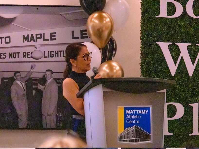 Donette Chin-Loy Chang speaking at podium delivering opening remarks.