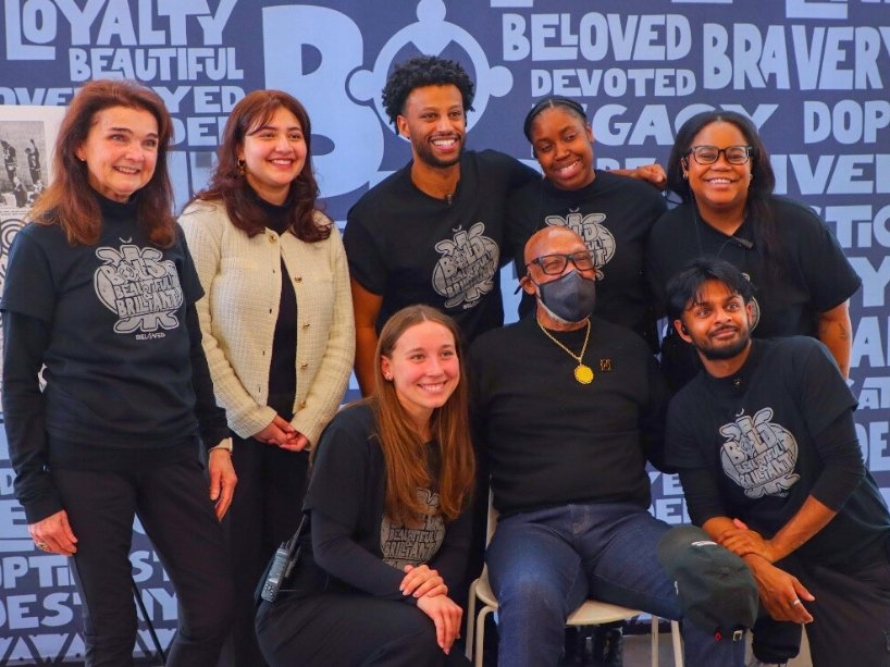 Group photo of athletics and recreation staff with Dr. John Carlos