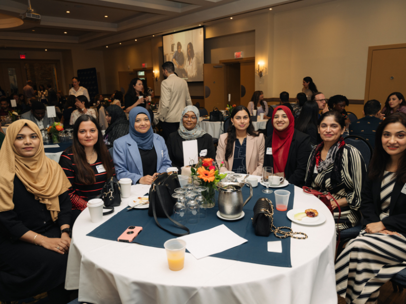A group of resident physicians posing together and smiling at the camera.