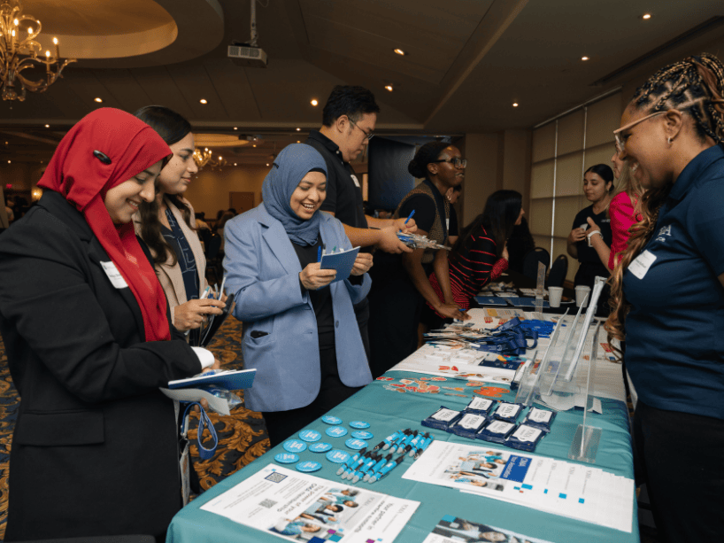  A group of people checking out a booth.