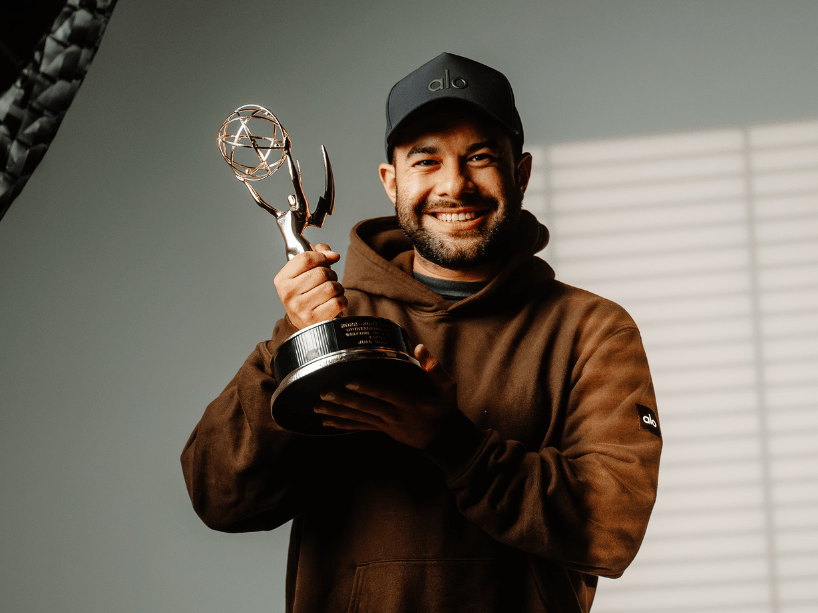 Juan Morales holding an Emmy.