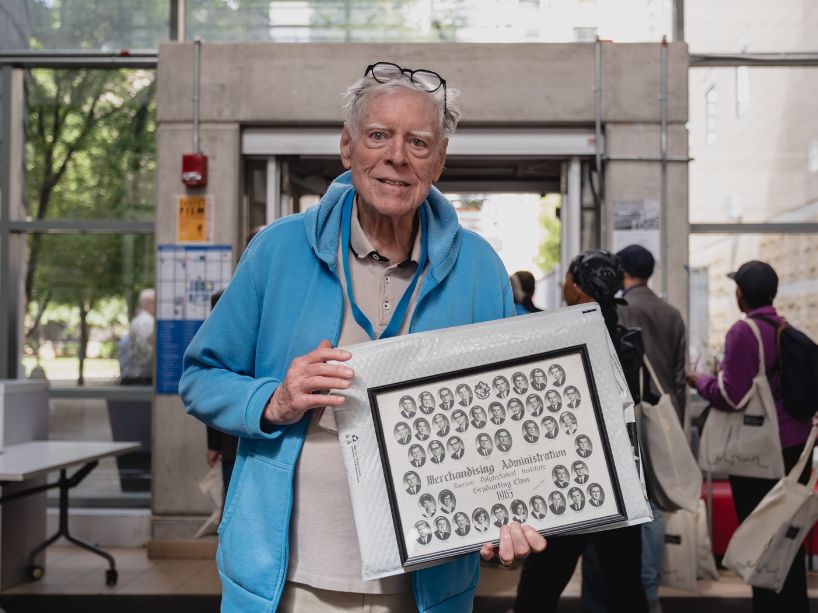 John Myers holding his class graduation photo from 1965.