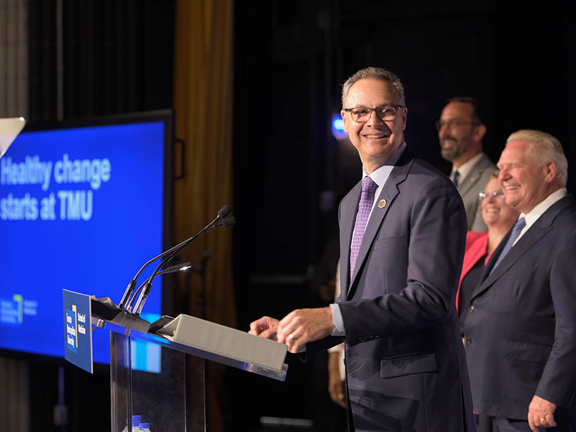 Orlando Corporation President Blair Wolk speaking at podium. 