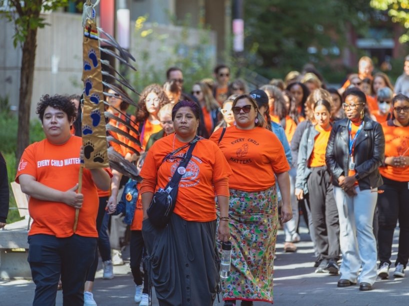The TMU community participating in a memorial walk on Orange Shirt Day.