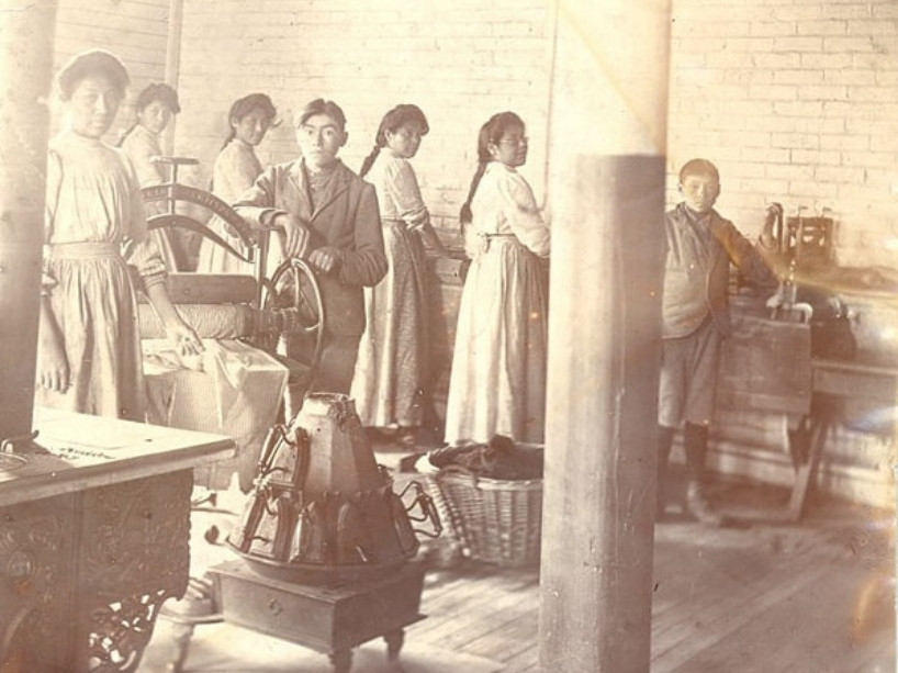 An archival image of workers in a laundry room.