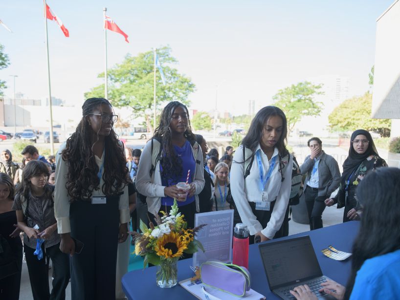 Inaugural TMU medical students check in at the registration desk outside the new School of Medicine in Brampton. 