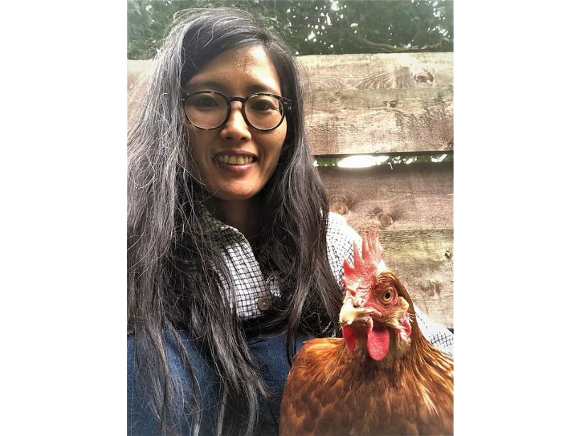 Chizuru Nobe-Ghelani holding a rooster.