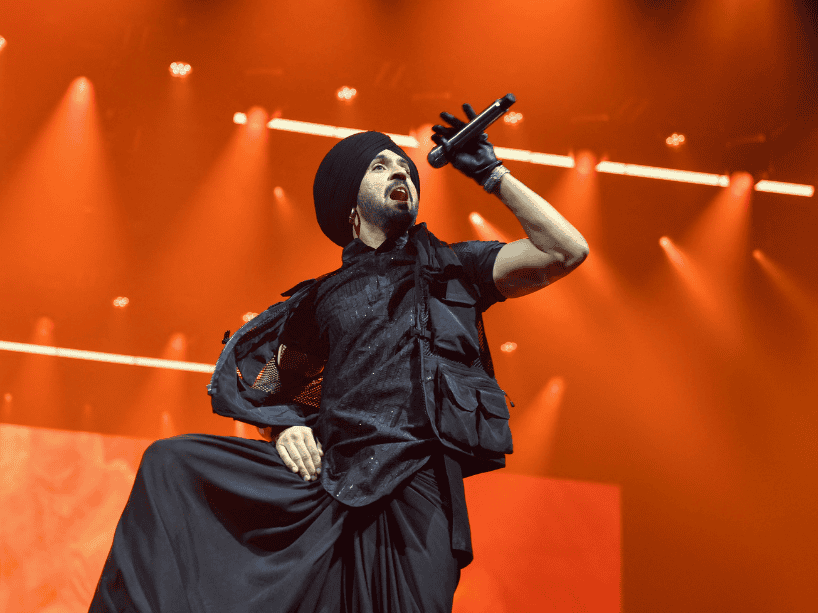 Diljit Dosanjh on stage mid-performance.