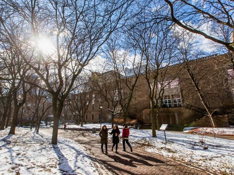 Students walking through a snowy campus. 