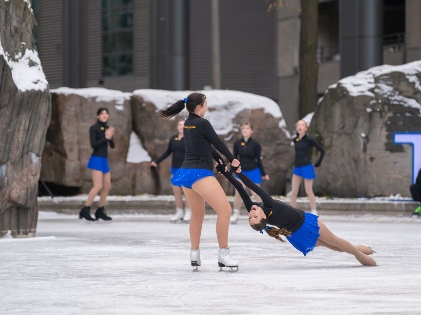 Members of the TMU figure skating team perform on Lake Devo.