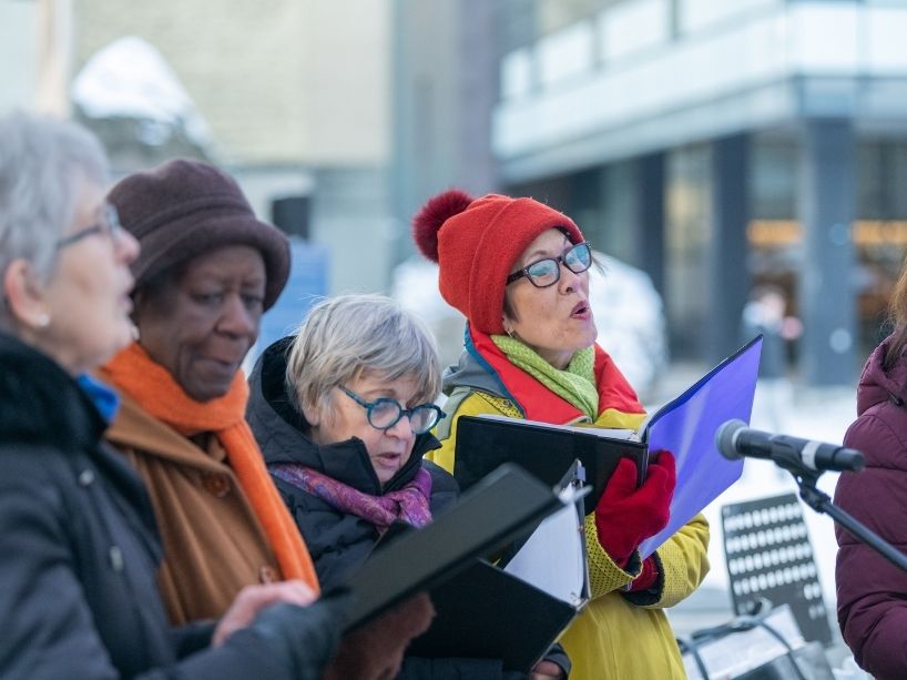 Four people in a choir singing.