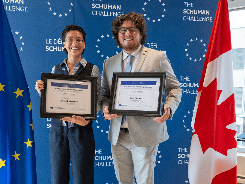  Cassandra Ferworn and Riley Martens posing with certificates. 