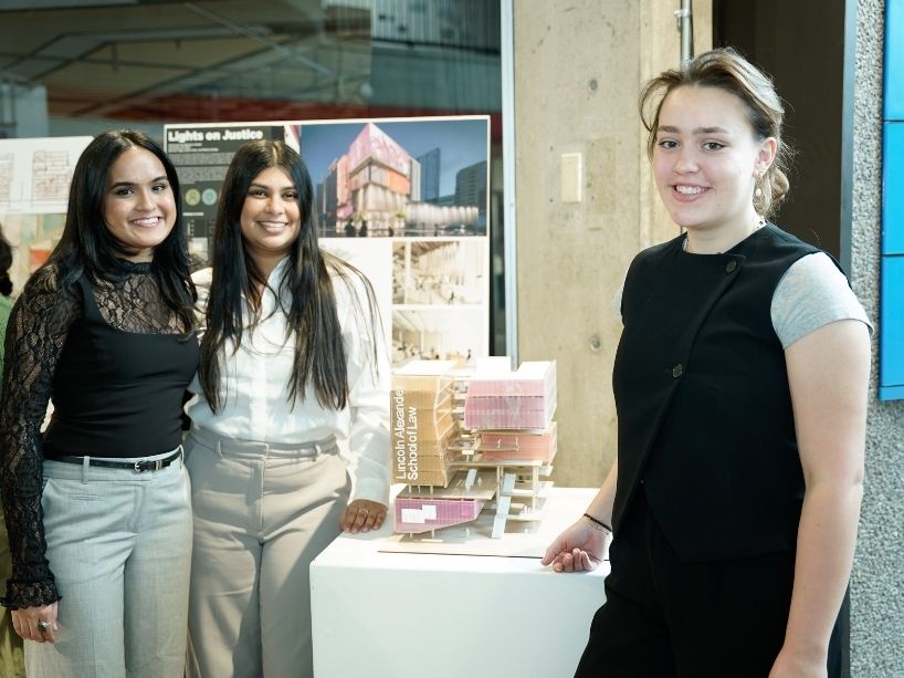 Brianna Vaga (left), Rishita Shukla (centre) and Sarah Vonk (right) pose for a photo with their building model and poster.