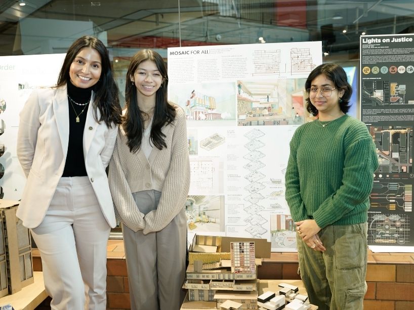 Aminah Haghighi (left), Evelyn Foster (centre) and Preetul Pasha (right) pose for a photo with their building model and poster.