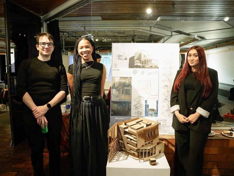 Lorenzo Spessotto (left), Caitlyn Alegbe (centre) and Afra Anan (right) pose for a photo with their building model and poster.
