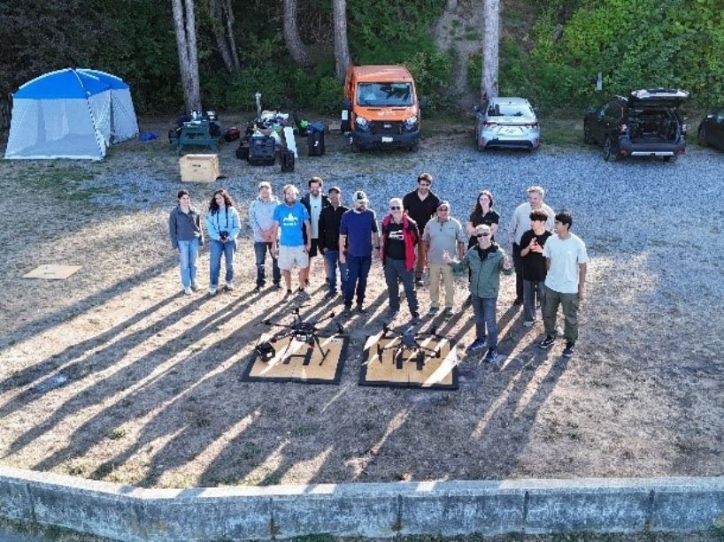 Team of TMU researchers, along with researchers from NRC, the University of Victoria and the University of Ottawa, standing next to drone platforms.
