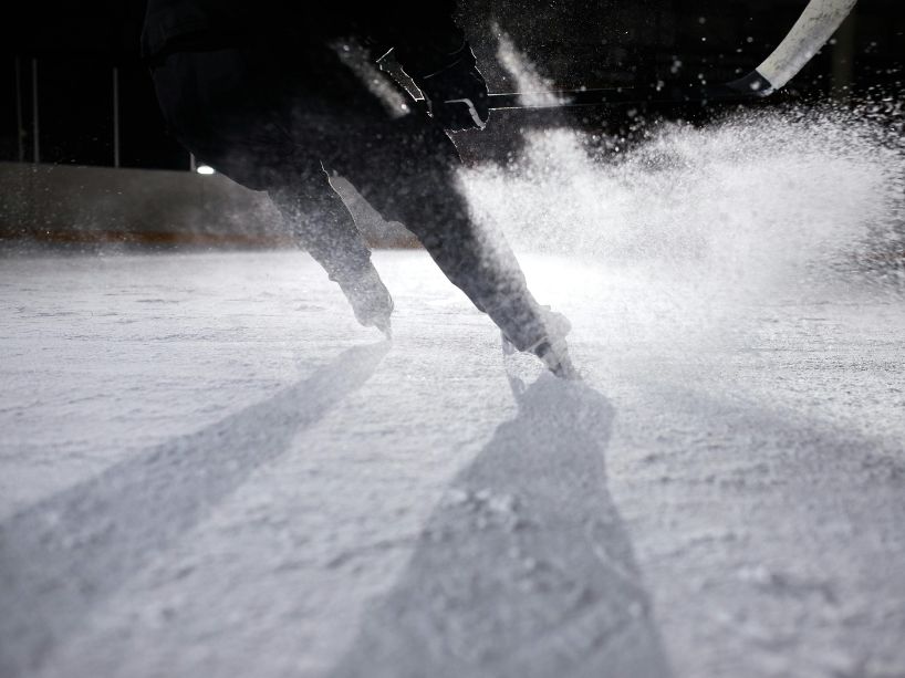 Black and white photo of a hockey player on the ice