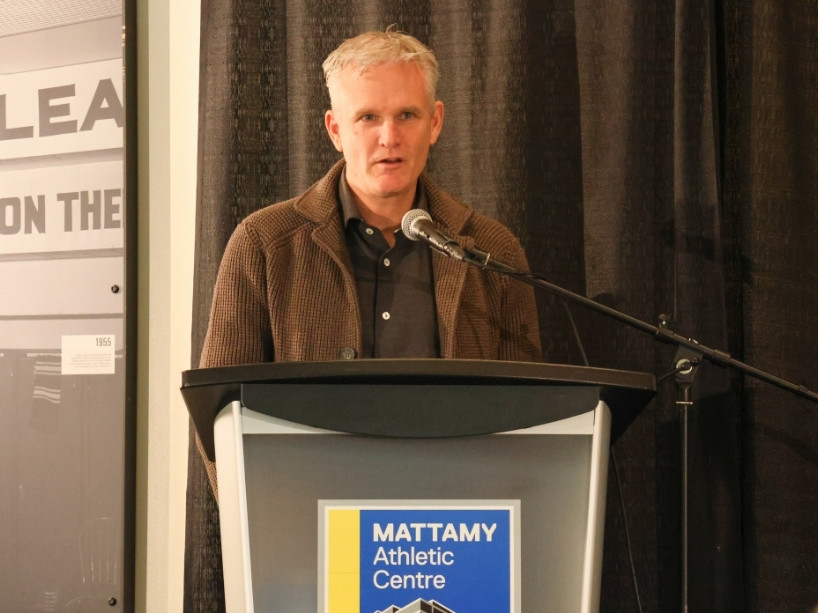 Rick Westhead speaks into a microphone at a podium.
