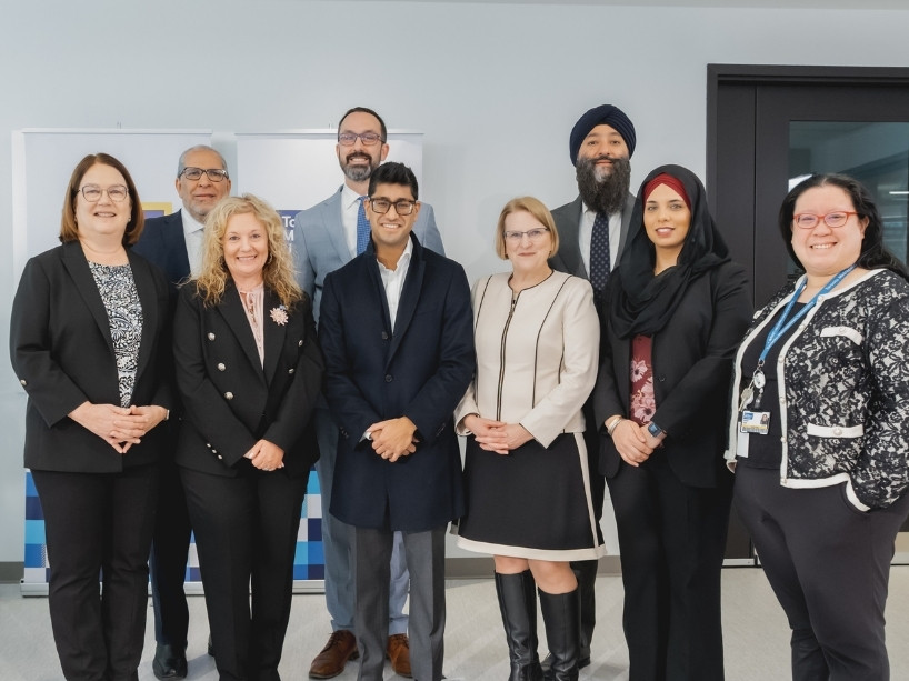 Nine people posing for a photo.