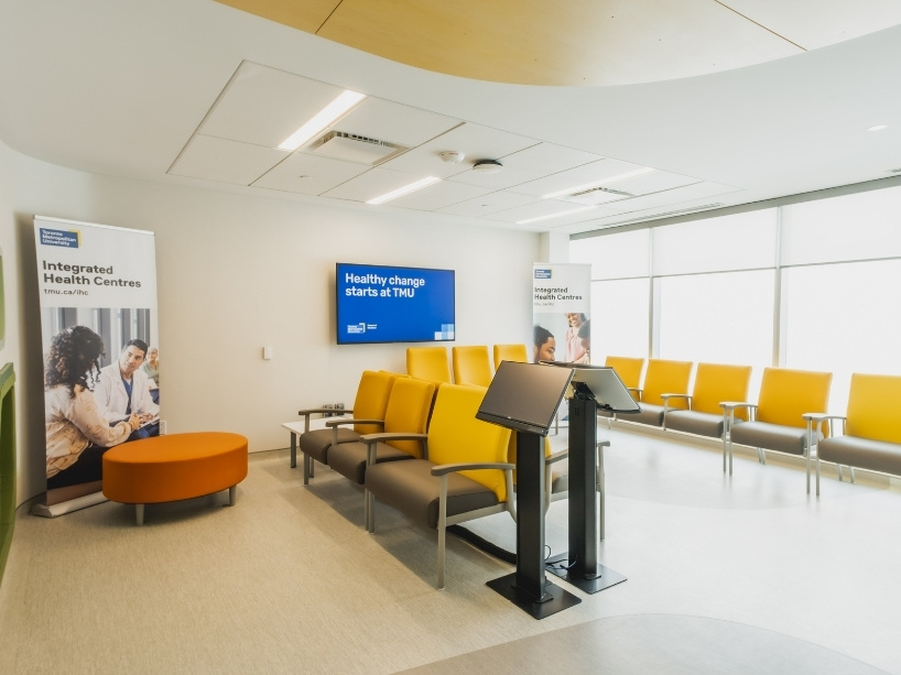 The waiting room of an IHC within the TMU School of Medicine gleams new with orange and gray chairs lined up and ready for future patients.