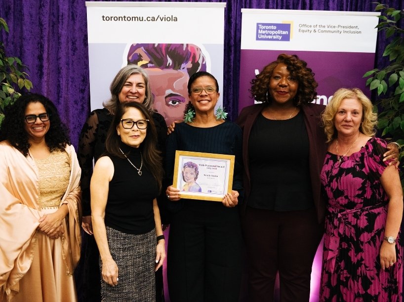 A group of five TMU leaders pose for a photo with the TMU Viola Desmond Staff Award winner. 