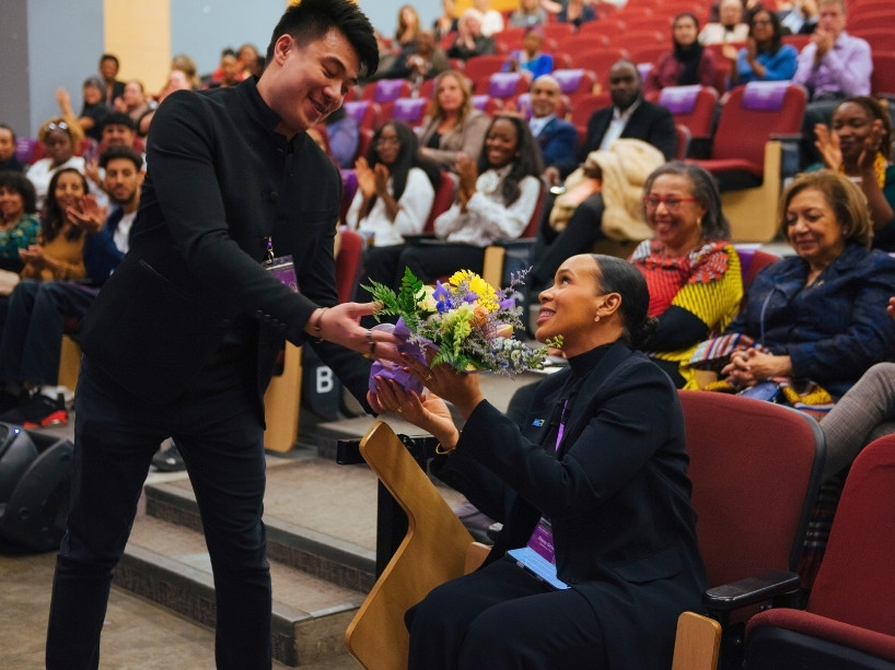 Ebony Gittens receiving flowers from Andy Tran.