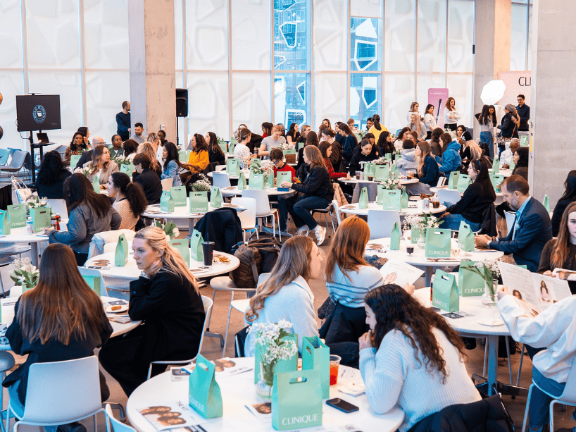  Attendees sitting at tables in event room.