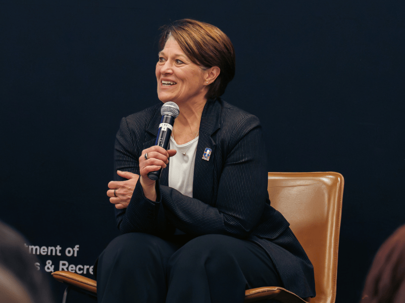 Sharon Bollenbach holding microphone. 