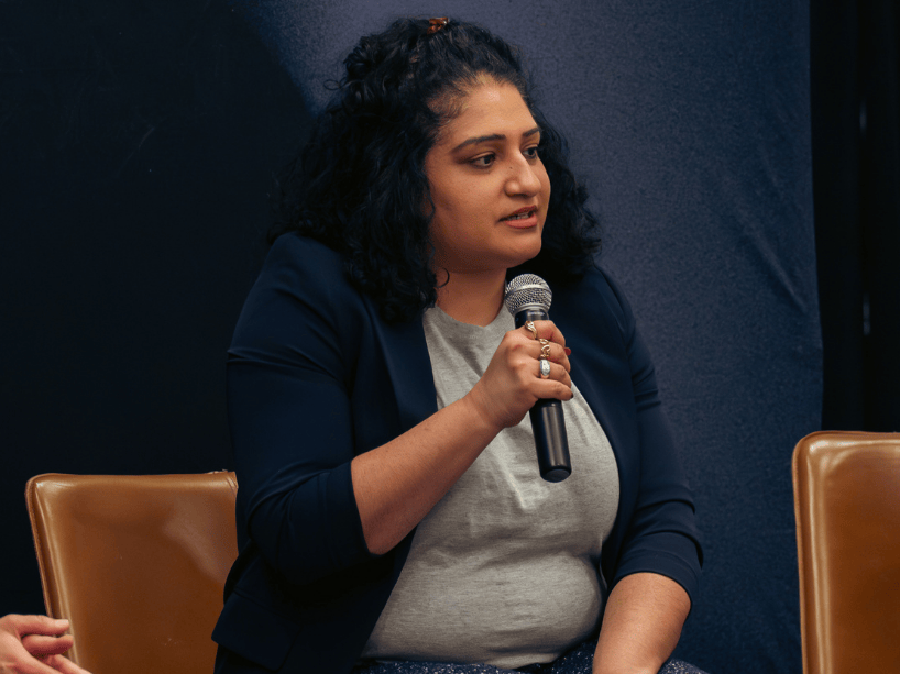 Manpreet Pandha holding microphone.