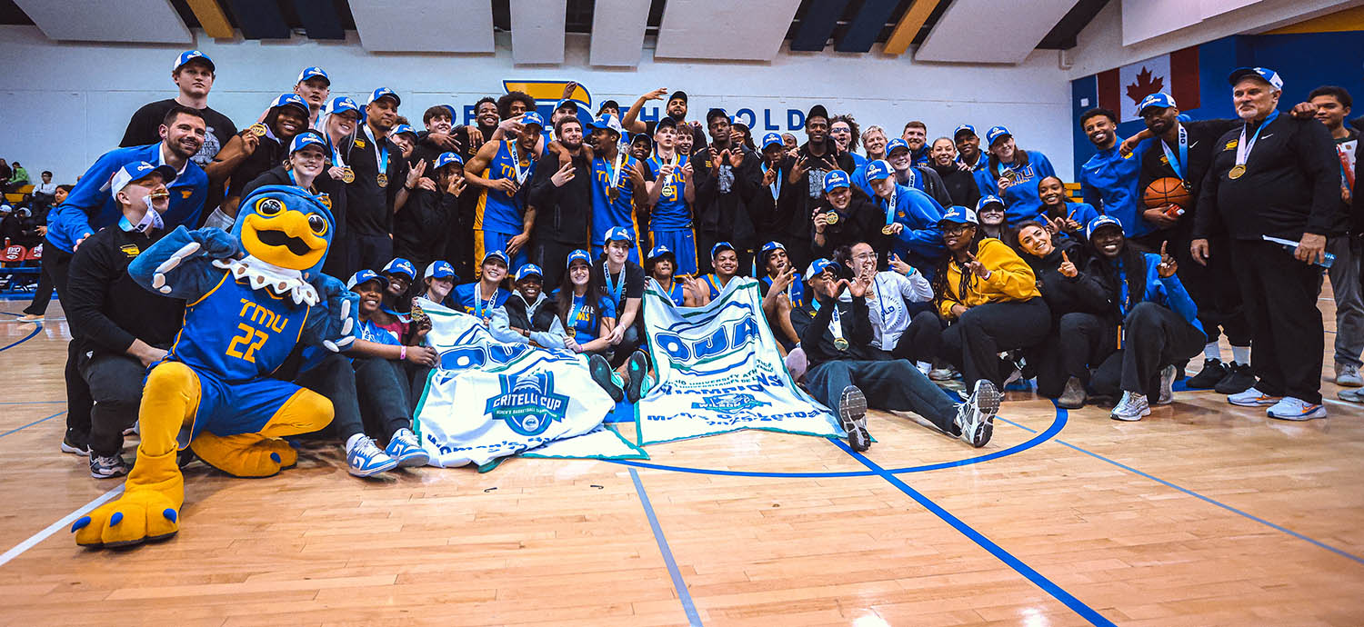 A large group of male and female basketball players pose for photos while celebrating their championship wins.