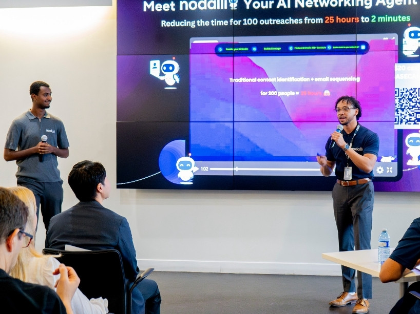 Two people giving a presentation to a room of people.