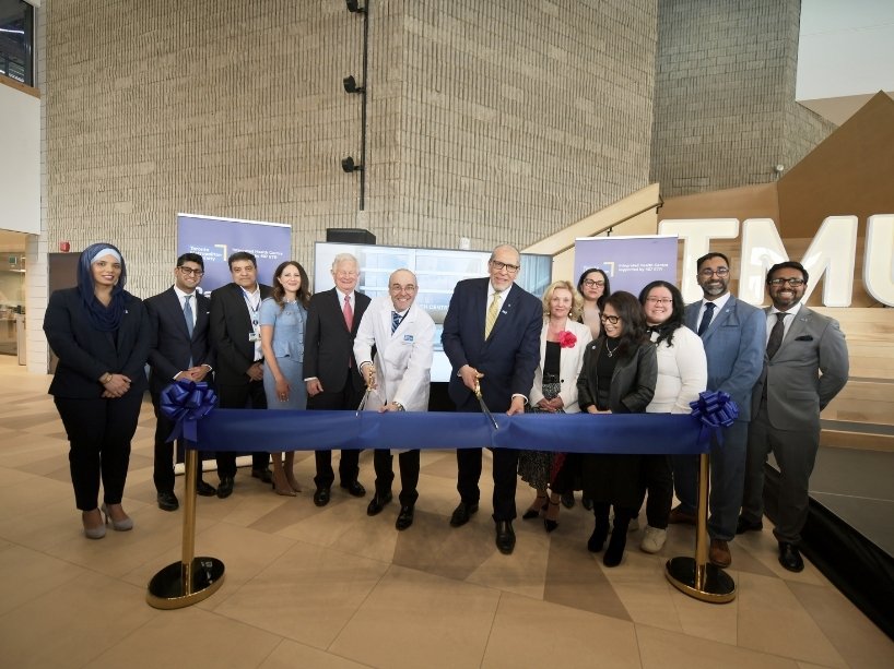 Leaders prepare to cut a ribbon at the official opening of TMUs flagship IHC.