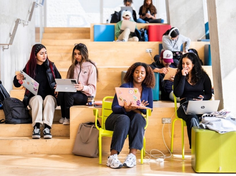 Students working on laptops in the SLC.