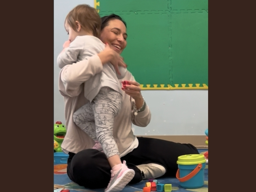 Irma Canut hugs a small child.