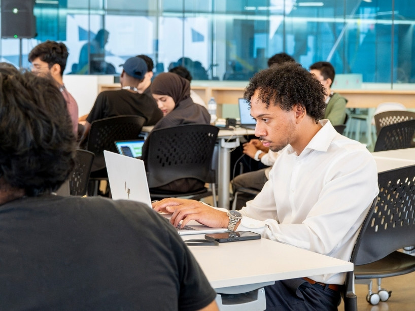 Students working at laptops.