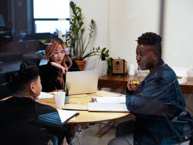 A group of people sitting around a table together.