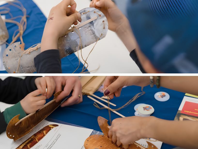 A close-up of participant hands threading twine through a canoe cut-out