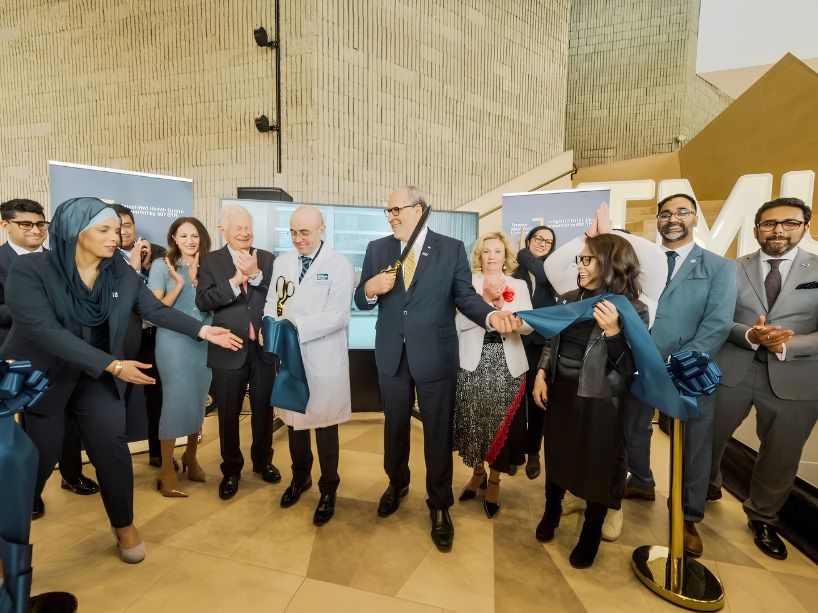 TMU leaders along with 407 ETR executive team members participate in a ceremonial ribbon cutting to officially open the new Integrated Health Centre.