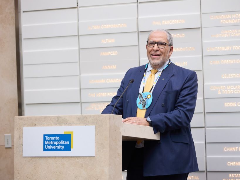 President Mohamed Lachemi at podium.