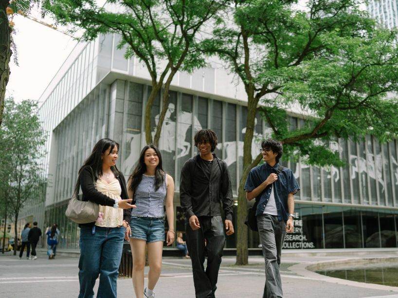 Students laughing on campus together.