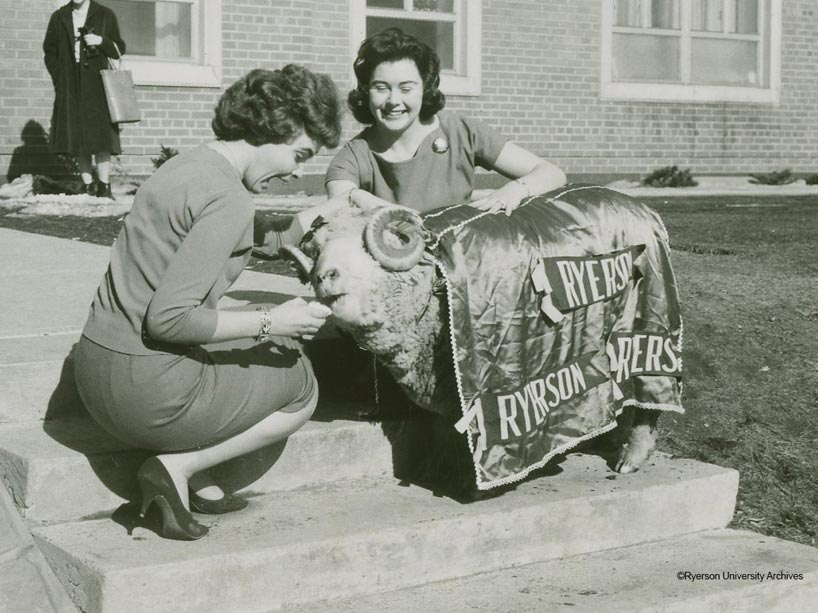 Black and white photo of two female students with Eggy the Ram