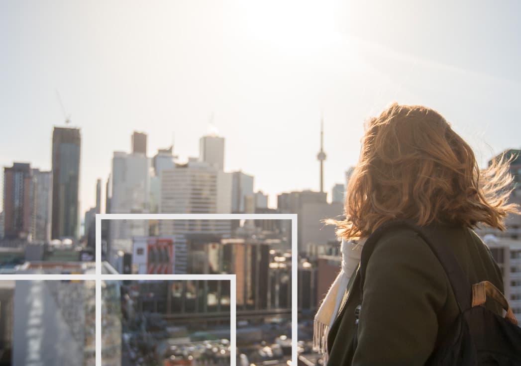 back shot of a student looking down on campus with CN tower in the background, with transparent shapes overlaid on top