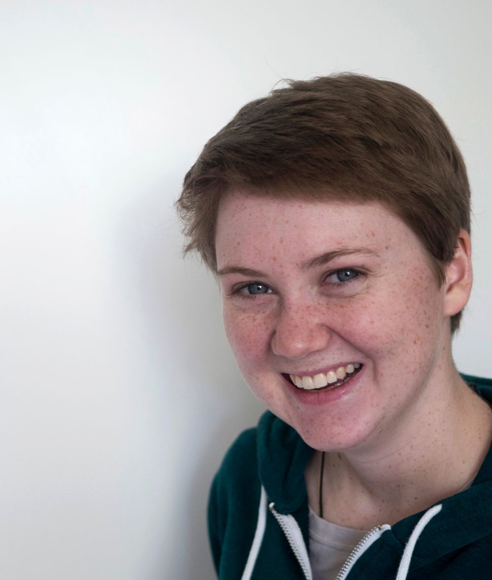 anna smiles at the camera against a white background. 