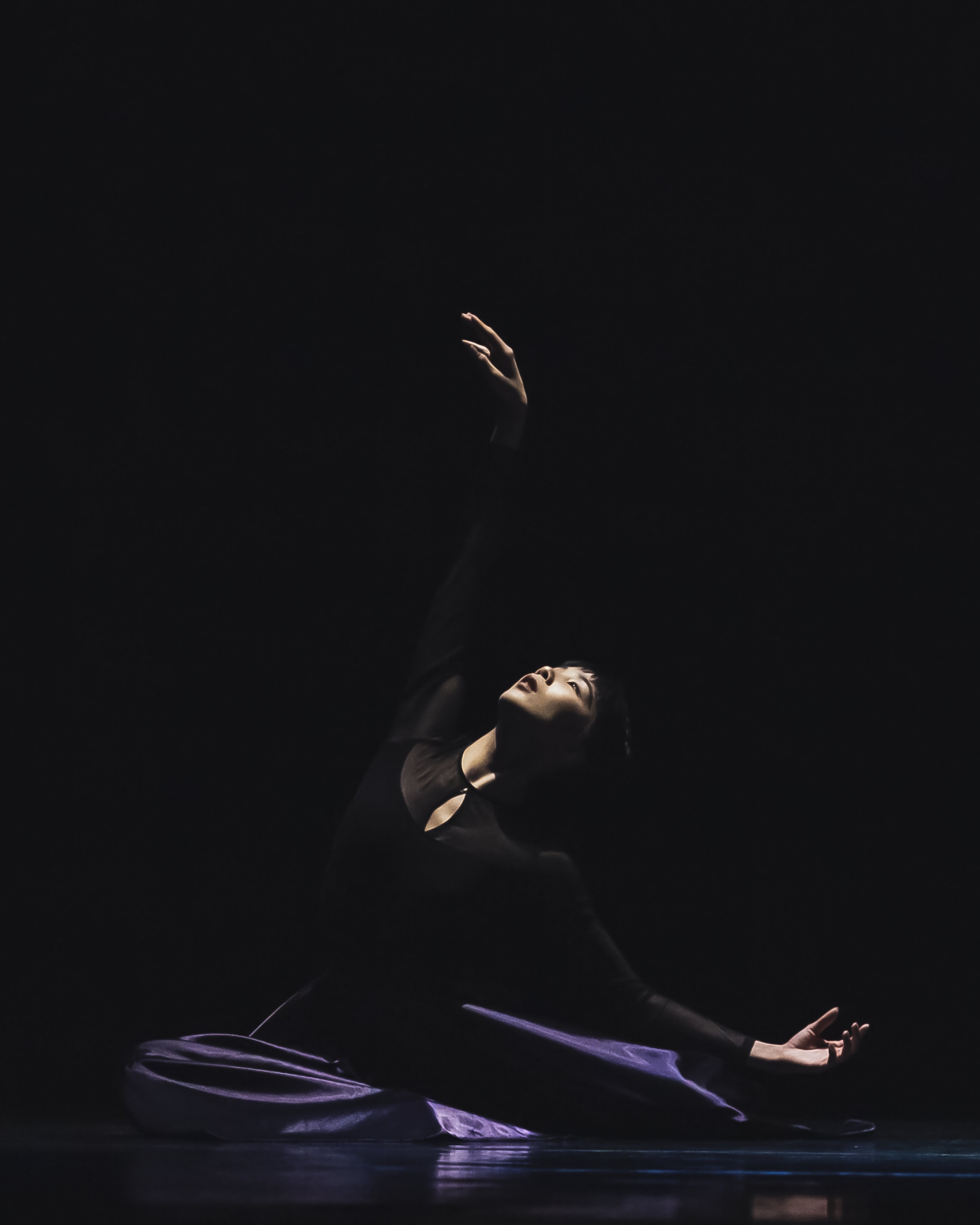 seated dancer reaching