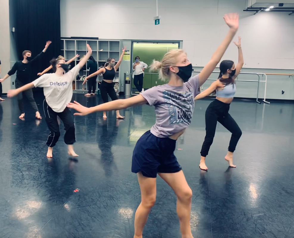 Dancers steps with arms outstretched 