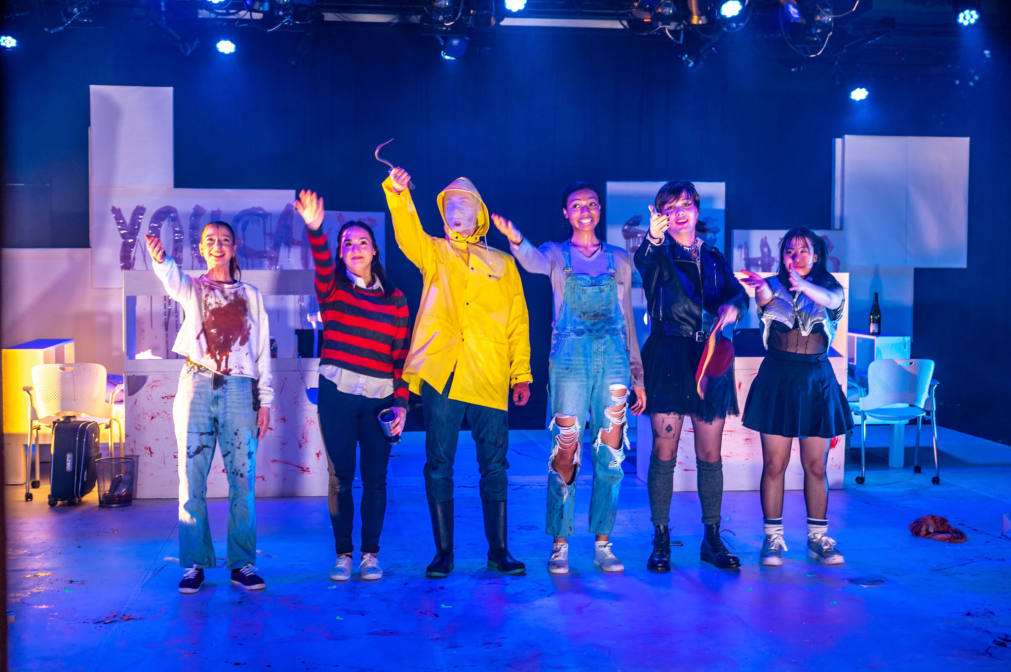 Actors gesture towards the stage management team taking their final bow