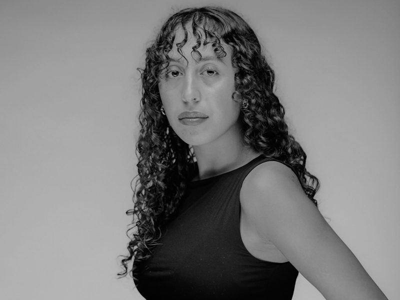 Isabella in black and white, she stares intently at the camera.