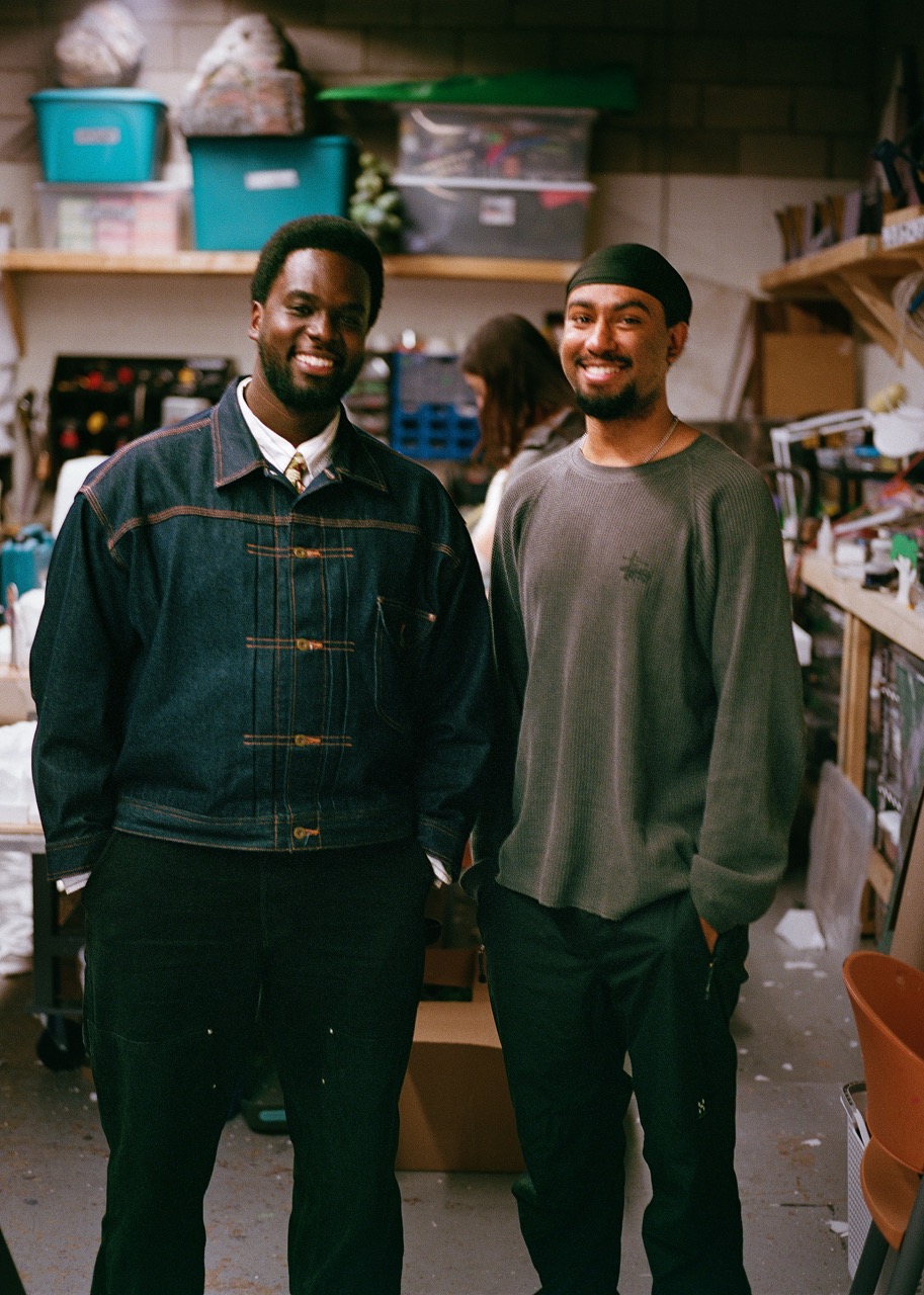 Michael and Akash stand together in a production studio 