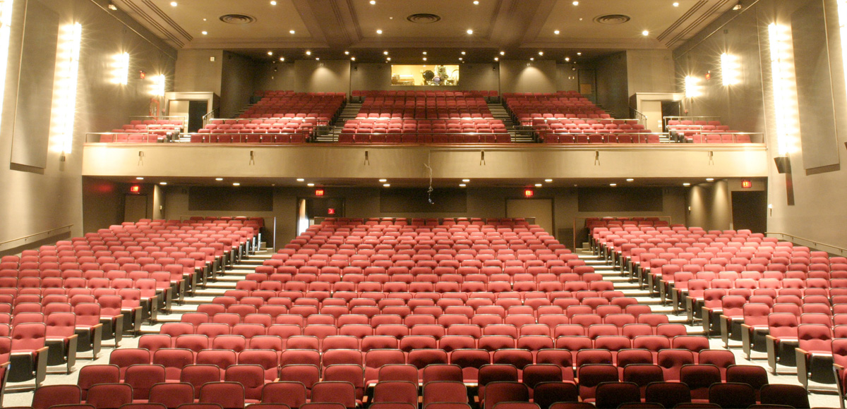Empty red seats of the Ryerson Theatre, as viewed from the stage.