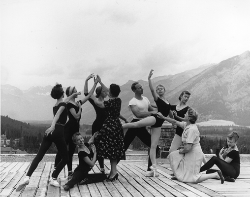 a group of dancers in front of a mountain